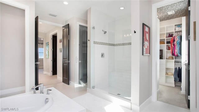 bathroom featuring separate shower and tub and tile patterned floors