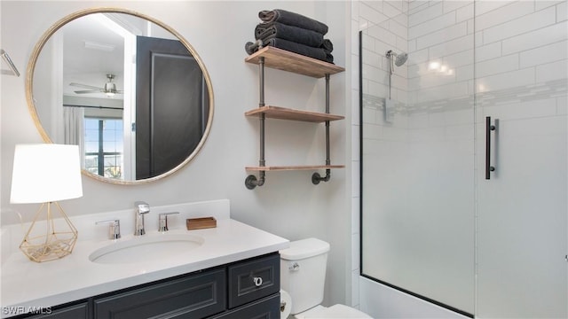 bathroom featuring ceiling fan, toilet, an enclosed shower, and vanity