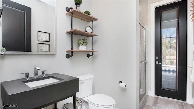 bathroom with vanity, an enclosed shower, and toilet