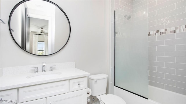 full bathroom with vanity, ceiling fan, toilet, and enclosed tub / shower combo