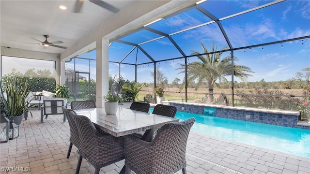 view of swimming pool with a lanai, ceiling fan, and a patio