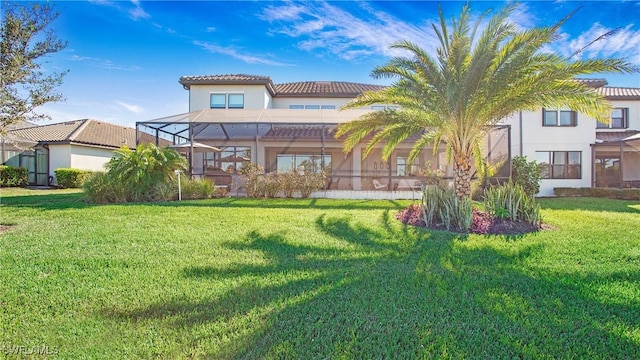 rear view of property featuring a lanai and a yard