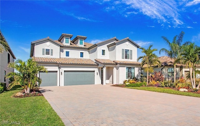 mediterranean / spanish-style house with a front yard and a garage