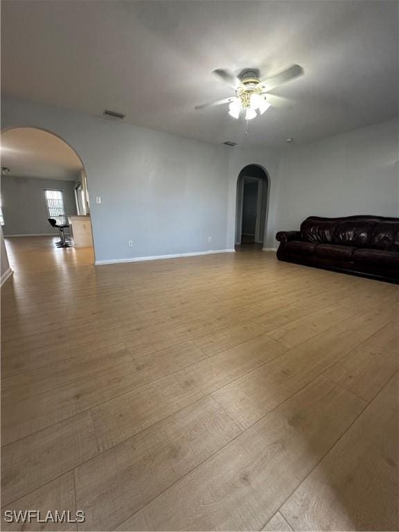 unfurnished living room with light hardwood / wood-style flooring and ceiling fan