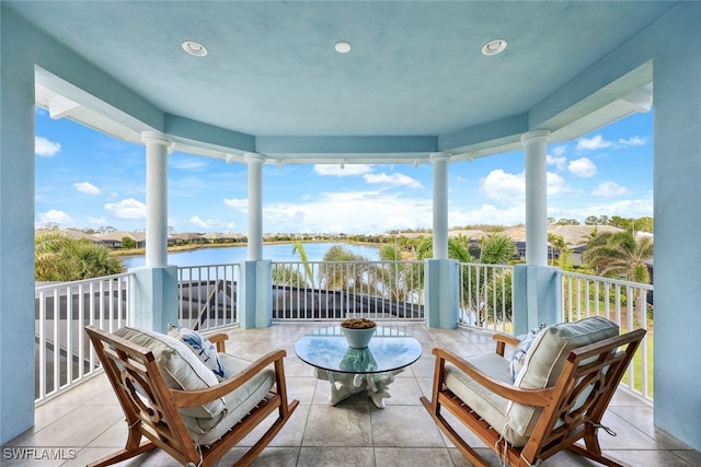 exterior space featuring a water view and ornate columns