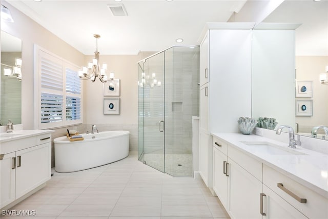 bathroom featuring a freestanding tub, visible vents, a stall shower, and a sink