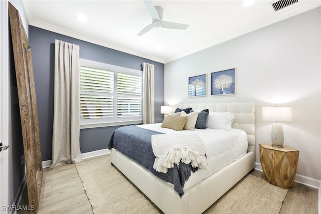 bedroom with visible vents, baseboards, crown molding, and light wood-style floors