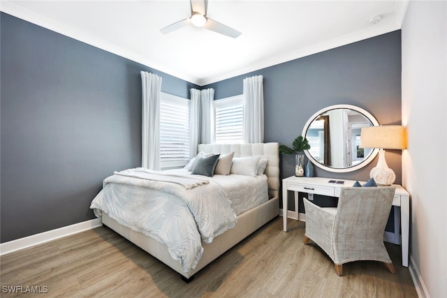 bedroom with a ceiling fan, baseboards, and wood finished floors