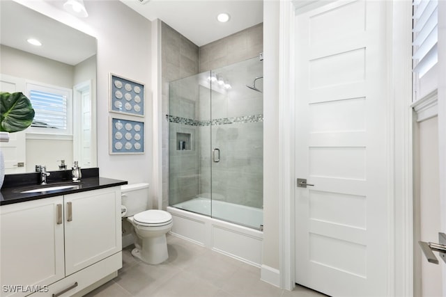 full bath featuring tile patterned flooring, bath / shower combo with glass door, toilet, recessed lighting, and vanity