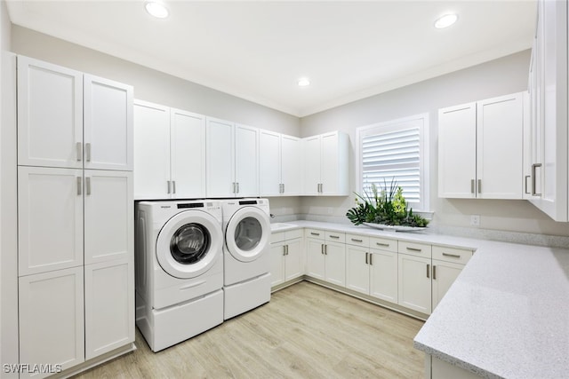 laundry room with washer and dryer, cabinet space, recessed lighting, and light wood finished floors