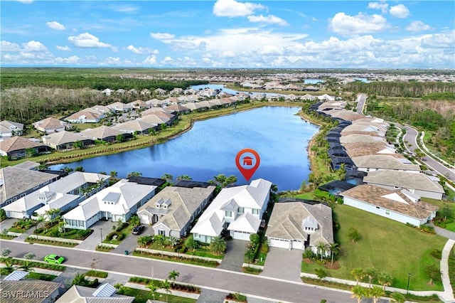 drone / aerial view with a residential view and a water view