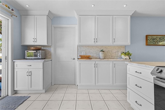 kitchen featuring tasteful backsplash, white cabinets, stainless steel electric stove, and light tile patterned floors