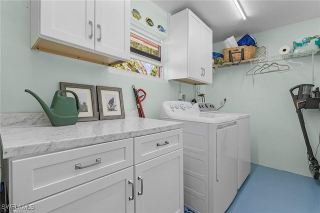 washroom featuring cabinets and independent washer and dryer