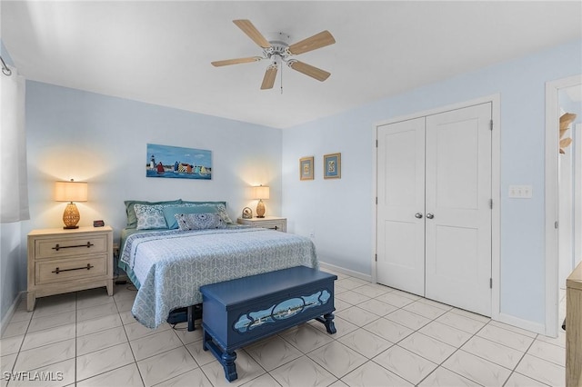 tiled bedroom with ceiling fan and a closet