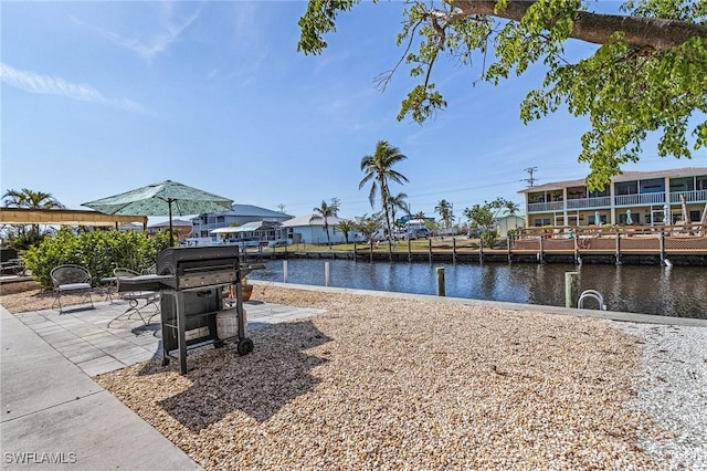 dock area featuring a patio area and a water view