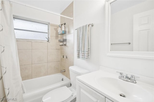 full bathroom featuring vanity, toilet, and shower / tub combo with curtain