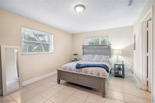 tiled bedroom with a textured ceiling