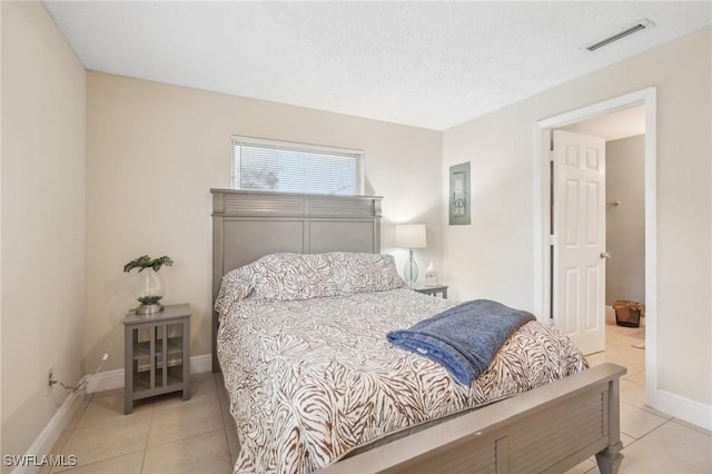 tiled bedroom with a textured ceiling