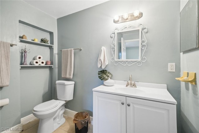 bathroom with tile patterned flooring, vanity, and toilet