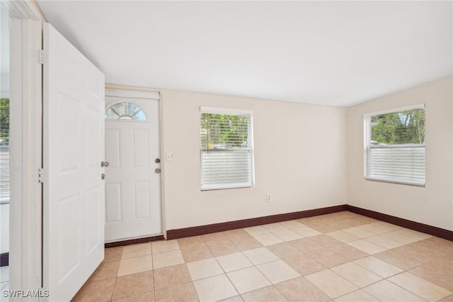 foyer entrance with light tile patterned flooring