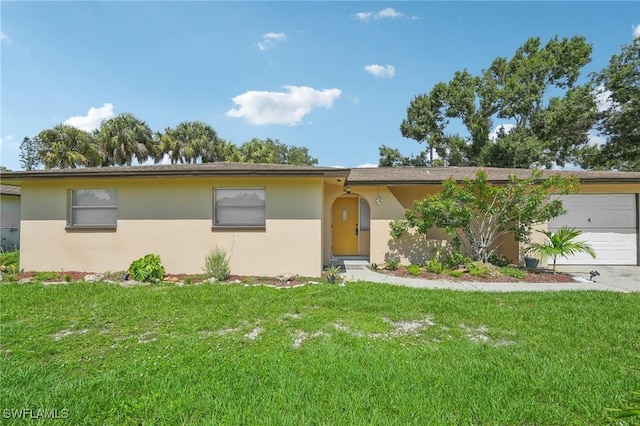 single story home featuring a garage and a front lawn