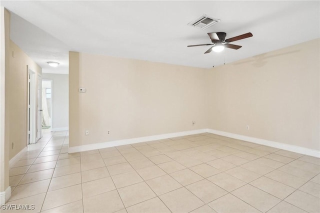 tiled spare room with ceiling fan