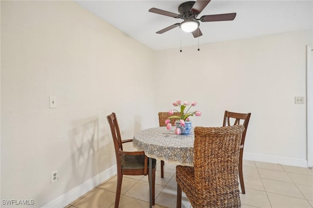 dining space featuring light tile patterned floors and ceiling fan