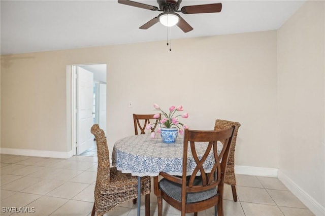 tiled dining space with ceiling fan