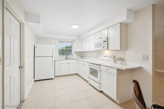 kitchen featuring white cabinets, white appliances, and sink