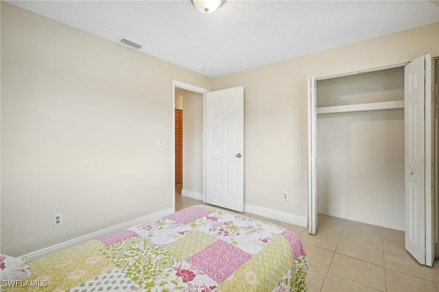 unfurnished bedroom with a closet and light tile patterned flooring