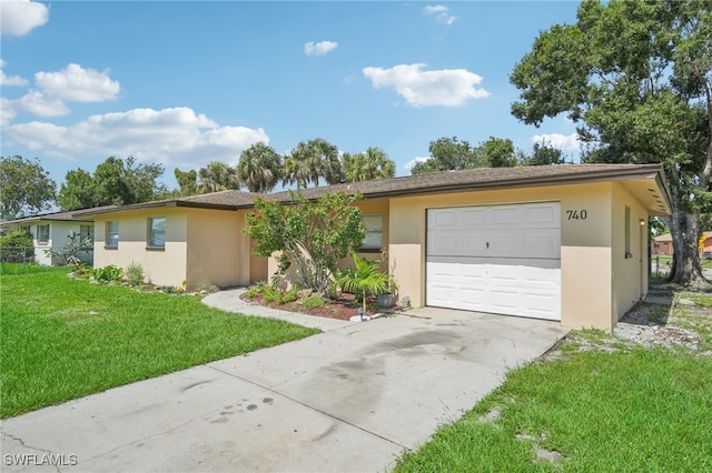 single story home featuring a garage and a front lawn