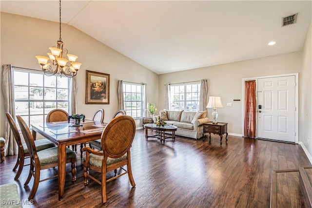 dining area featuring a chandelier, dark wood-type flooring, and lofted ceiling