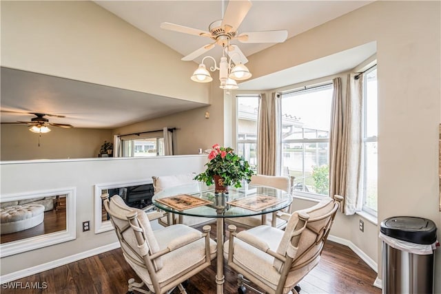 dining area featuring dark wood-type flooring and vaulted ceiling