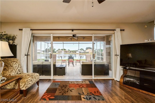 living room featuring ceiling fan and wood-type flooring