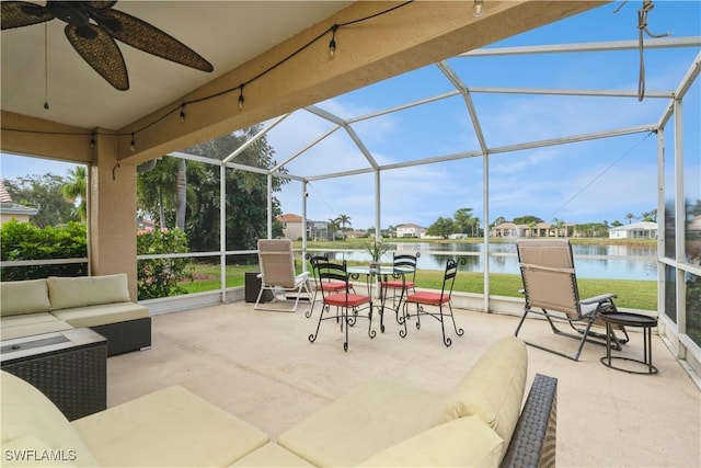 view of patio featuring outdoor lounge area, a water view, ceiling fan, and a lanai