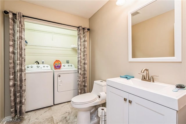 bathroom with vanity, toilet, and independent washer and dryer