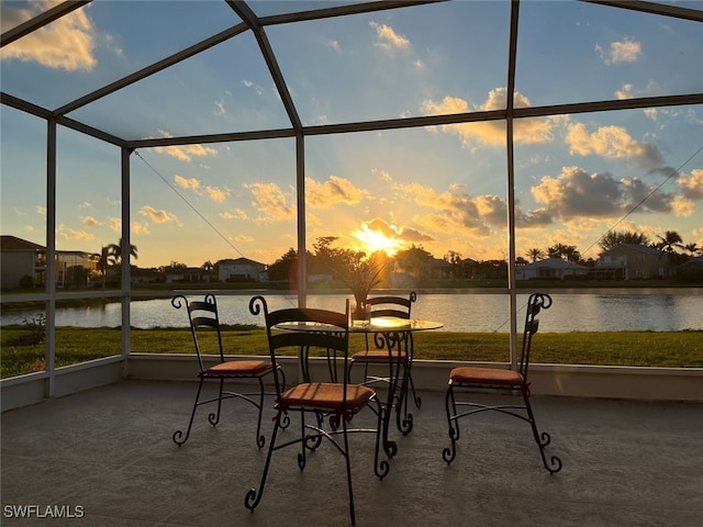 sunroom / solarium with a water view