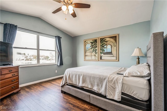 bedroom featuring ceiling fan, dark hardwood / wood-style floors, and vaulted ceiling