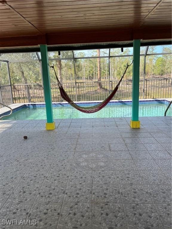 view of pool with glass enclosure