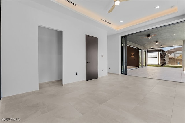 spare room featuring a raised ceiling