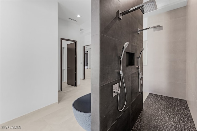 bathroom with a tile shower