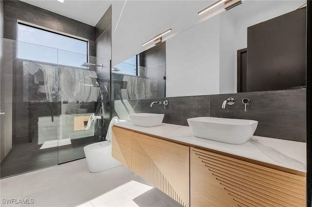 bathroom featuring tasteful backsplash, tile patterned flooring, vanity, and a shower with shower door