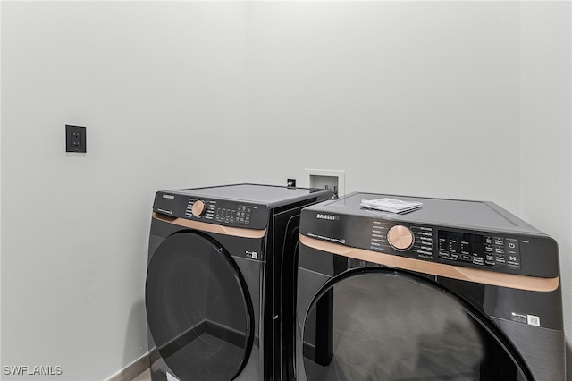 clothes washing area with separate washer and dryer