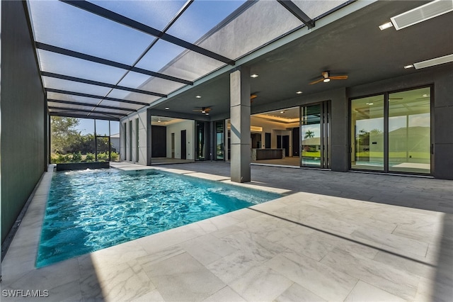 view of swimming pool with ceiling fan, a patio area, and a lanai