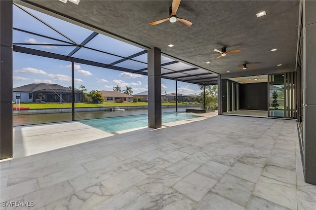 view of swimming pool featuring glass enclosure, ceiling fan, and a patio area