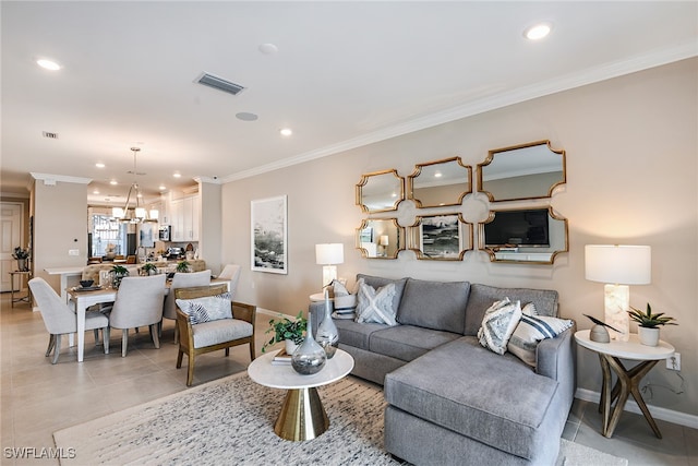 living room with a chandelier, light tile patterned floors, and ornamental molding