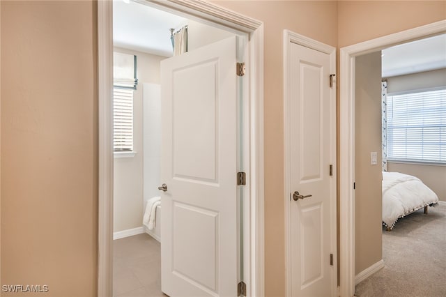 hallway featuring light carpet