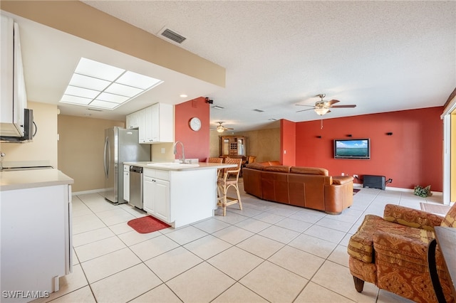 kitchen with ceiling fan, sink, white cabinets, and appliances with stainless steel finishes