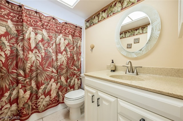 bathroom featuring tile patterned flooring, vanity, and toilet