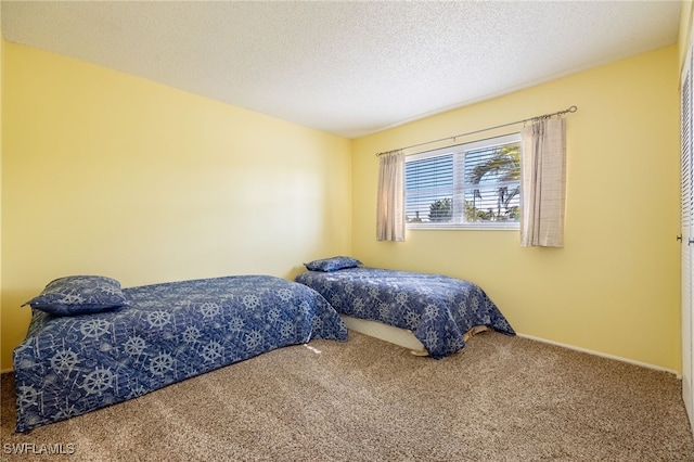 bedroom with carpet and a textured ceiling